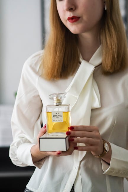 Woman holding luxury perfume bottle